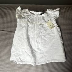 Girls White Gap Shirt Size 18-24 Months Nwt Fitted White Gap Top, White Fitted Top By Gap, Gap Ruffled Tops For Summer, Summer Ruffled Tops By Gap, Summer Ruffled Tops From Gap, Gap Ruffled Short Sleeve Tops, Cute Gap Cotton T-shirt, Gap Cotton Tops For Summer, White Spring Blouse For Playtime