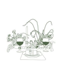 a table with flowers and wine glasses on it, next to a vase filled with flowers