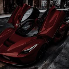 a red sports car is parked on the street