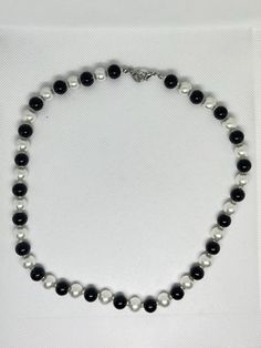 Beautiful, quality, black and white faux pearl necklace with tiny clear bead spacers in between each pearl. This classy necklace is 19 inches in length with a silver tone clasp. It would make a beautiful gift, or purchase for yourself. Happy shopping! Black And White Pearl Necklace, Classy Necklace, White Pearl Necklace, Wedding Jewellery Necklace, Faux Pearl Necklace, White Pearl, Wedding Necklace, Pearl White, Faux Pearl