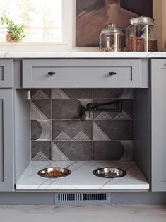 a kitchen with two bowls on the stove