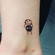 a small tattoo on the ankle of a person wearing a chef's hat and eyeballs