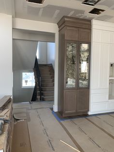 an empty room is being remodeled with new flooring and cabinets in the process of being installed