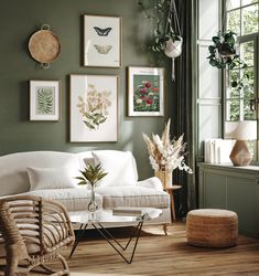 a living room with green walls and pictures on the wall above the white couches