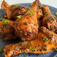 chicken wings with herbs and seasoning on a blue plate