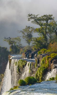 the water is running down the side of the waterfall