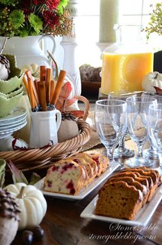 a wooden table topped with lots of food and drinks