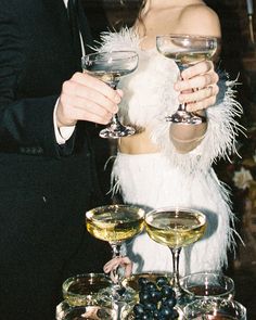 a man and woman holding wine glasses in their hands