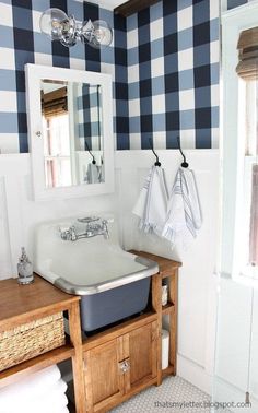 a white sink sitting under a mirror in a bathroom next to a wooden counter top