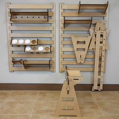 two pieces of wood sitting on top of a tile floor next to each other in front of a wall