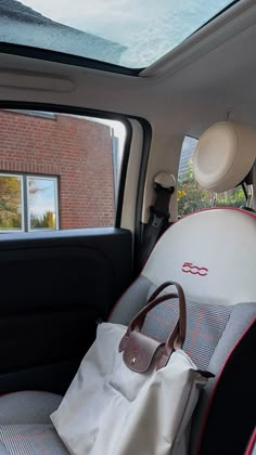 the back seat of a car with a handbag in it's front pocket