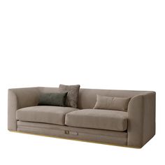 a beige couch with two pillows on it