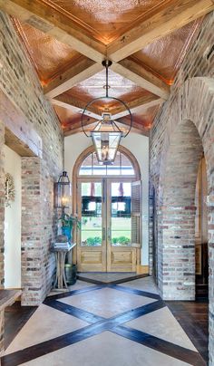 an entry way with brick walls and arched doorways is pictured in this image from the inside