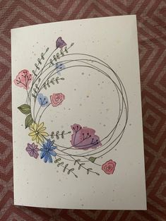 a card with flowers and leaves on it