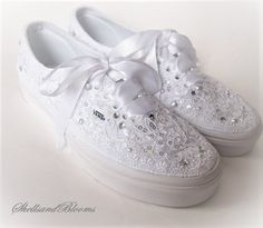 a pair of white shoes with bows and sequins on the bottom are shown