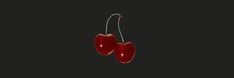 two red cherries hanging from a hook on a black background with space for text