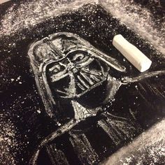 a chalk drawing of a darth vader with snow on the ground next to it