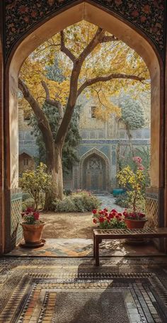 an archway leading into a courtyard with potted plants and flowers on the ground in front of it