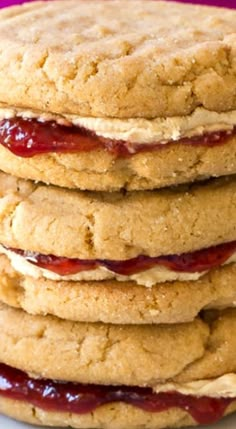 a stack of cookies with jelly on top