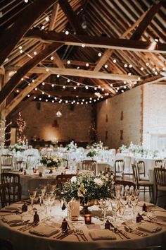 Dark neutral wedding tablescape at barn wedding venue reception room with fairy lights intertwined into wooden beams Minimalist Dekor, Barn Wedding Reception, Sage Green Bridesmaid Dress, Green Themed Wedding, Barn Wedding Decorations, Sage Wedding, Dream Wedding Venues, Sage Green Wedding, Rustic Barn Wedding