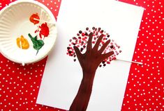 a paper plate with an image of a tree on it next to a piece of paper