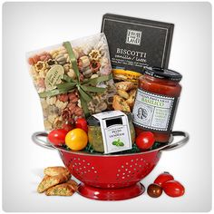 a red colander filled with assorted food and condiments for a gift