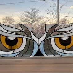 an owl's eye is painted on the glass in front of a building window