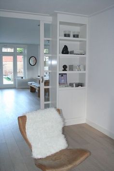 a living room filled with furniture and white walls