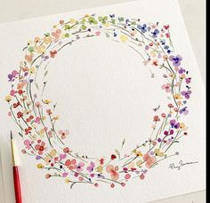 a watercolor painting of a flower wreath