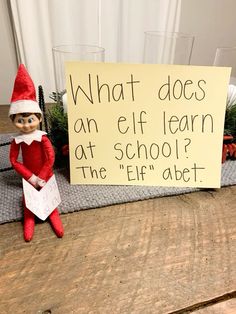 an elf holding a sign that says what does an elf learn at school? the elf is next to it