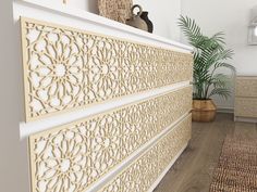 a large white bed sitting in a bedroom next to a plant