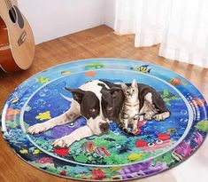 a dog laying on the floor next to a cat with an ocean theme rug in front of it