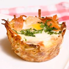 an egg and cheese cupcake on a white plate