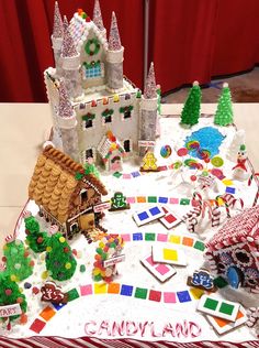 a cake decorated with gingerbread houses and candy canes