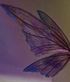 a purple butterfly flying through the air