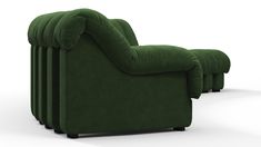 a green couch sitting on top of a white floor