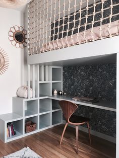 a room that has some shelves and a desk in it with a chair next to it