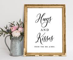 a sign that says hugs and kisses from the mr and mrs on it next to a vase with flowers