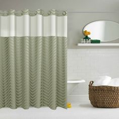 a bathroom with a sink, mirror and shower curtain in beige colors on the wall