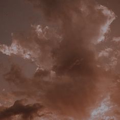 an airplane is flying in the sky at sunset