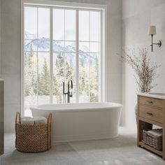 a large white bath tub sitting next to a window in a room with a wooden dresser