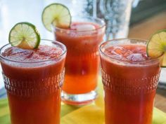 two glasses filled with drinks sitting on top of a table