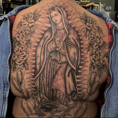 the back of a woman's body with tattoos on it