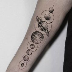 a person with a tattoo on their arm that has different planets and stars in it