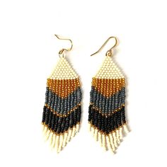 "Handmade fringe earrings using Toho 11/0 seed beads. Lightweight earrings. Gold plated ear wires. Approximately 3\" long and 1\" wide. Adds a beautiful statement to your wardrobe. Earrings are in ivory, gold, gray, and black. Each piece is designed by me and handwoven with care and attention to detail which can take several hours to complete.  SHIPPING: Tasha Jane Designs uses USPS Ground Advantage.  If needed in a quicker timeline, please message me. Shipping charges will be adjusted to reflect a different timeline. CARE INSTRUCTIONS:  I recommend beaded earrings are stored either in a hanging position or flat. It is recommended that you do not expose your jewelry to harsh chemicals or extended time in water as this may change the color of the beads.  If the fringe does not hang straight Mardi Gras Jewelry, Gold Beaded Earrings, Blue And White Earrings, Handwoven Earrings, Gold Bead Earrings, Jewelry Words, Chic Earrings, Lightweight Earrings, Beaded Hoop Earrings