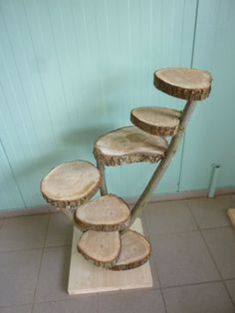 a stack of wooden logs sitting on top of a tiled floor