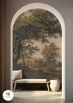 an archway with a painting on the wall next to a white couch and table in front of it