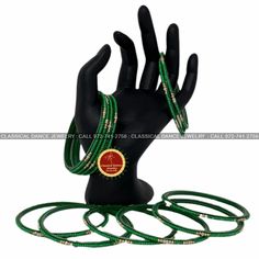 green bracelets with gold beads on a mannequin's head and hand