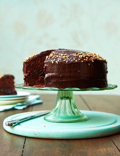 a chocolate cake sitting on top of a green plate