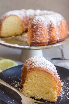 a bundt cake with powdered sugar on top and a slice missing from it